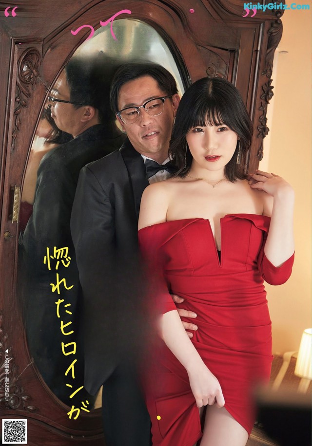 a woman in a red dress standing next to a man in a tuxedo