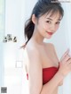 A woman in a red dress posing for a magazine.
